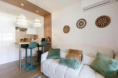 a living room with a couch and a table at Cannes proche Croisette et palais magnifique appartement 4 couchages in Cannes