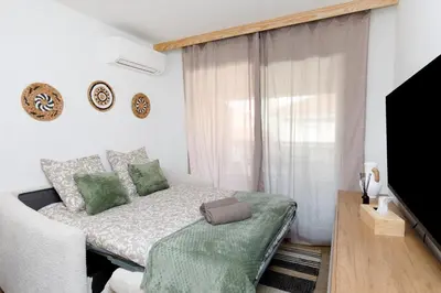 a small bedroom with a bed and a television at Cannes proche Croisette et palais magnifique appartement 4 couchages in Cannes