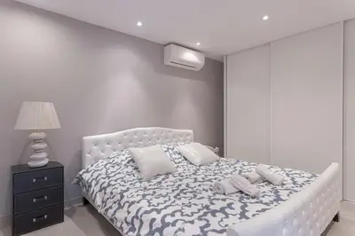 a bedroom with a bed and a red wall at Duplex Saint-henry by Halldis in Cannes