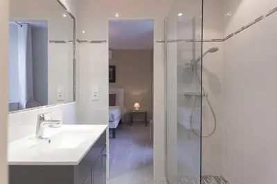 a bathroom with a bath tub and a bed at Duplex Saint-henry by Halldis in Cannes