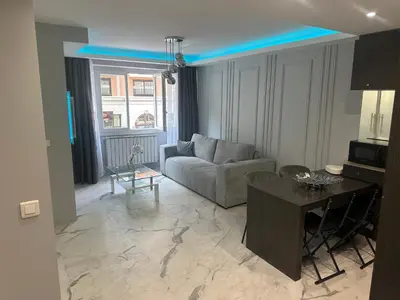 a living room with a couch and a table at Apartment best position croisette martinez ! 150m from the beach completely renovated ! in Cannes