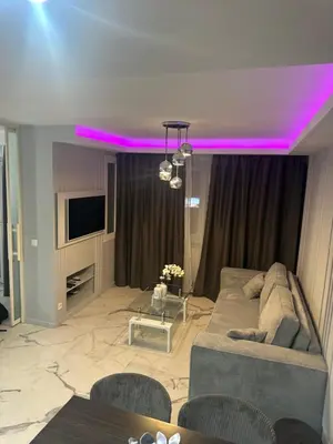 a living room with a couch and a tv at Apartment best position croisette martinez ! 150m from the beach completely renovated ! in Cannes