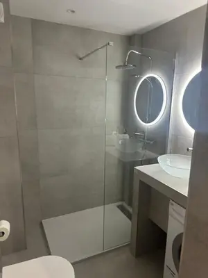 a bathroom with a glass shower and a sink at Apartment best position croisette martinez ! 150m from the beach completely renovated ! in Cannes