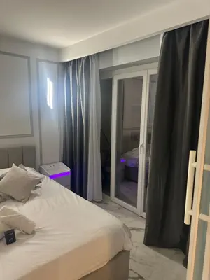 a bedroom with a bed and a large window at Apartment best position croisette martinez ! 150m from the beach completely renovated ! in Cannes