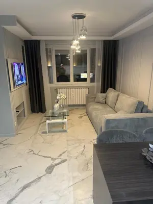 a living room with a couch and a table at Apartment best position croisette martinez ! 150m from the beach completely renovated ! in Cannes