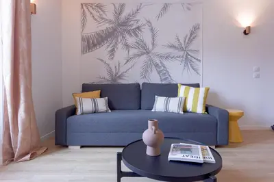 a living room with a blue couch and a table at Duplex Pradignac by Halldis in Cannes