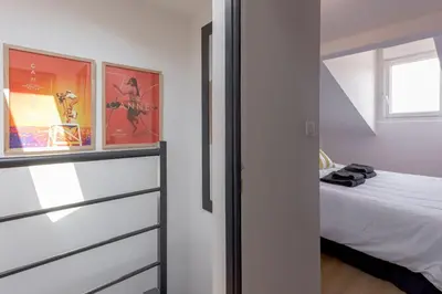 a small bedroom with a bed and a window at Duplex Pradignac by Halldis in Cannes