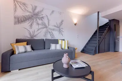 a living room with a couch and a table at Duplex Pradignac by Halldis in Cannes
