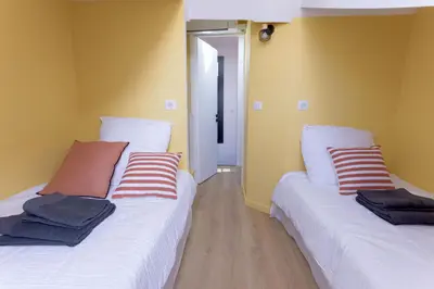 two beds sitting next to each other in a room at Duplex Pradignac by Halldis in Cannes