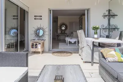 a living room with a couch and a table at Cannes centre - Vue Mer, Piscine, Terrasse in Cannes