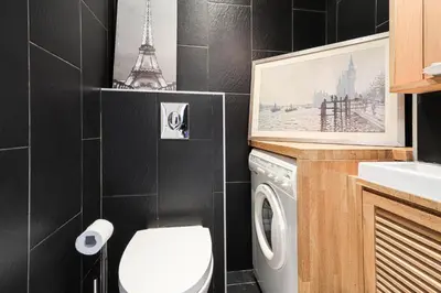a bathroom with a washer and dryer in it at Cannes centre - Vue Mer, Piscine, Terrasse in Cannes