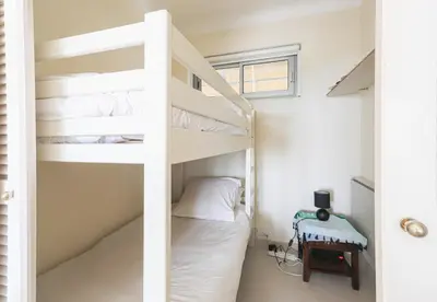 a bunk bed in a room with a bunk bed in a bedroom at Cannes centre - Vue Mer, Piscine, Terrasse in Cannes