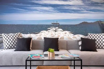 a couch sitting in front of the water with boats at cannes experience pastour DUPLEX Penthouse Rooftop 4 bed&4bath Sea&Suquet view walking distance palais des congres & beaches in Cannes