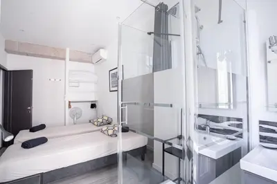 a bathroom with a shower and a bed and a sink at cannes experience pastour DUPLEX Penthouse Rooftop 4 bed&4bath Sea&Suquet view walking distance palais des congres & beaches in Cannes
