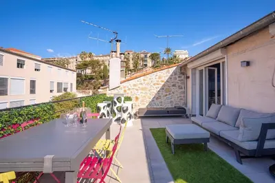 a patio with a table and chairs on a balcony at cannes experience pastour DUPLEX Penthouse Rooftop 4 bed&4bath Sea&Suquet view walking distance palais des congres & beaches in Cannes