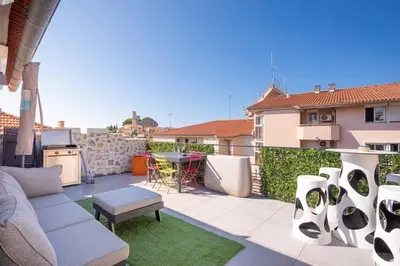 a patio with a couch and a table on a balcony at cannes experience pastour DUPLEX Penthouse Rooftop 4 bed&4bath Sea&Suquet view walking distance palais des congres & beaches in Cannes
