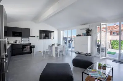 a white living room with a kitchen and a table at cannes experience pastour DUPLEX Penthouse Rooftop 4 bed&4bath Sea&Suquet view walking distance palais des congres & beaches in Cannes