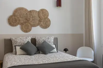 a bedroom with a bed with four wooden plates on the wall at Splendide et idéalement situé proche du palais. in Cannes