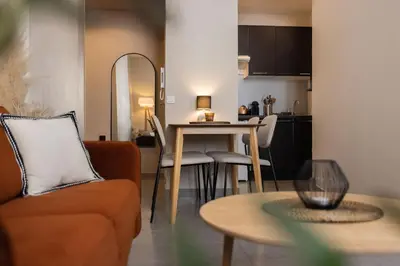 a living room with a couch and a table at Splendide et idéalement situé proche du palais. in Cannes