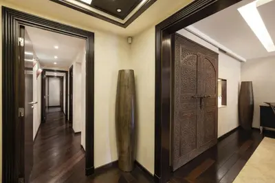 a hallway with a large wooden door and a hallway with stairs at Suite Jam - Superbe Appartement à Cannes in Cannes