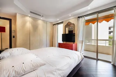 a bedroom with a large bed and a television at Suite Jam - Superbe Appartement à Cannes in Cannes