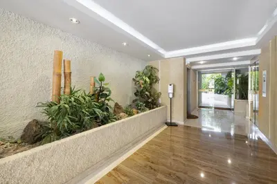 an empty hallway with plants in a building at Suite Jam - Superbe Appartement à Cannes in Cannes
