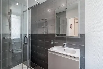 a bathroom with a sink and a shower with a mirror at BARBARA by Terry's Homes in Cannes
