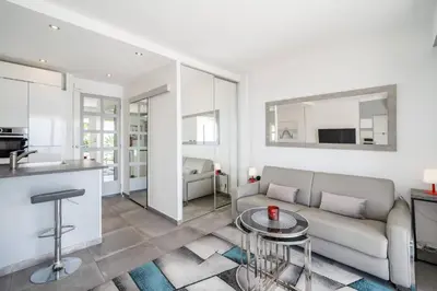 a living room with a couch and a table at Studio mer Croisette in Cannes