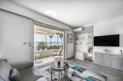 a living room with a couch and a television at Studio mer Croisette in Cannes
