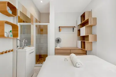 a small bathroom with a bed and a sink at Le Borniol, splendid 3 bedrooms Appt, Cannes Center in Cannes
