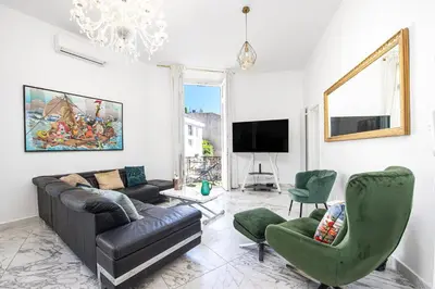 a living room with a couch and chairs and a tv at Le Borniol, splendid 3 bedrooms Appt, Cannes Center in Cannes