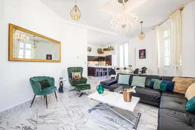 a living room with a black couch and green chairs at Le Borniol, splendid 3 bedrooms Appt, Cannes Center in Cannes