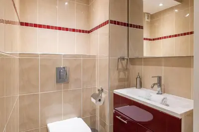 a bathroom with a toilet and a sink at La Palmeraie - Piscine et Toit Terrasse in Cannes