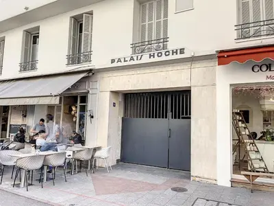 a restaurant with tables and chairs in front of a building at 1 bedroom Palais Hoche Cannes 5 mins from the Croisette Cannes Riviera 226 in Cannes