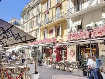 a city street with tables and chairs and buildings at 1 bedroom Palais Hoche Cannes 5 mins from the Croisette Cannes Riviera 226 in Cannes