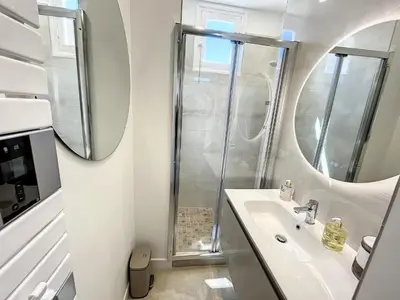 a bathroom with a sink and a shower at 1 bedroom Palais Hoche Cannes 5 mins from the Croisette Cannes Riviera 226 in Cannes