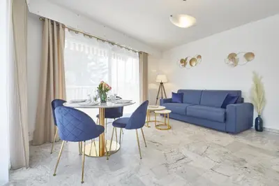 a living room with a blue couch and a table at Cannes centre-Palais-200m des plages in Cannes