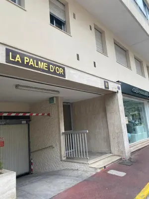 a building with a la palme dore sign on it at Cannes centre-Palais-200m des plages in Cannes