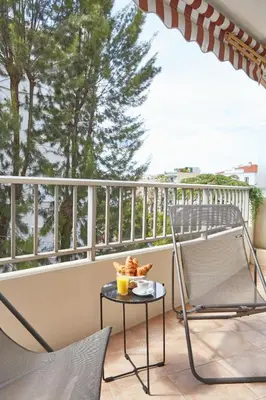 a bedroom with two beds and a large mirror at Cannes centre-Palais-200m des plages in Cannes