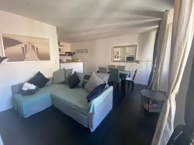 a living room with a couch and a table at Agréable T2 rénové, Cannes centre, Suquet, plages in Cannes
