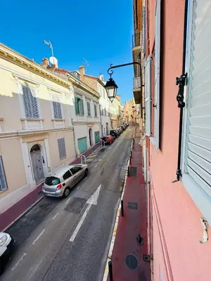 a city street with cars parked on the street at Agréable T2 rénové, Cannes centre, Suquet, plages in Cannes