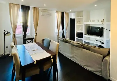 a living room with a couch and a table at Agréable T2 rénové, Cannes centre, Suquet, plages in Cannes