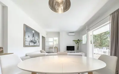 a white living room with a white table and chairs at Le Marilyn by Winsome Destination in Cannes
