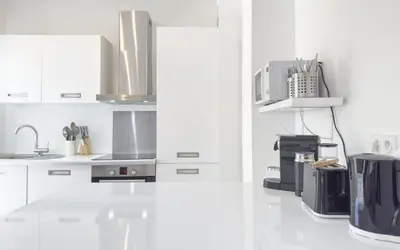 a kitchen with white cabinets and a sink at Le Marilyn by Winsome Destination in Cannes