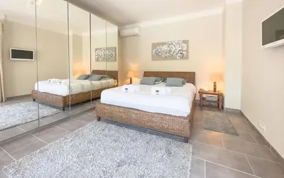 a bedroom with two beds and a mirror at Le Marilyn by Winsome Destination in Cannes