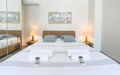 a large white bedroom with two beds and two lamps at Le Marilyn by Winsome Destination in Cannes