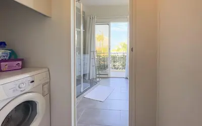 a laundry room with a washing machine and a balcony at Le Marilyn by Winsome Destination in Cannes
