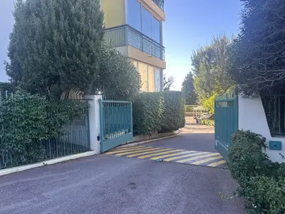 a gate in front of a house with a building at Le Marilyn by Winsome Destination in Cannes