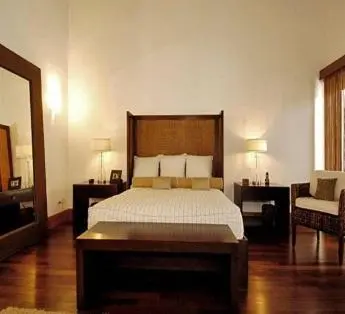 a bedroom with a bed and a chair and a mirror at Darbin ~ in Cannes
