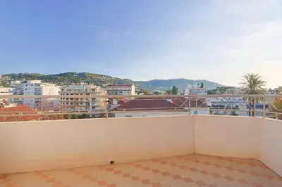 a balcony with a view of a city at L'impérator by Winsome Destination in Cannes